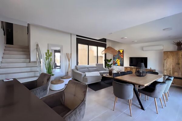 Living and kitchen area with cosy sofas in the house Grande